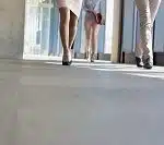 Low section of business people walking on flooring in office