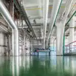 Alcohol production plant. Silvery rectification columns with many pipes.