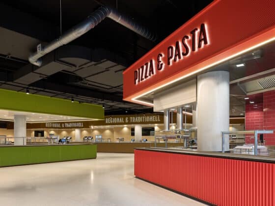 Modern food court featuring a red Pizza & Pasta counter; lime green service area in the background.