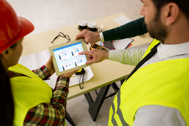 Bauprojektbeteiligte nutzen ein Tablet mit COMAN Suite zur digitalen Projektdokumentation