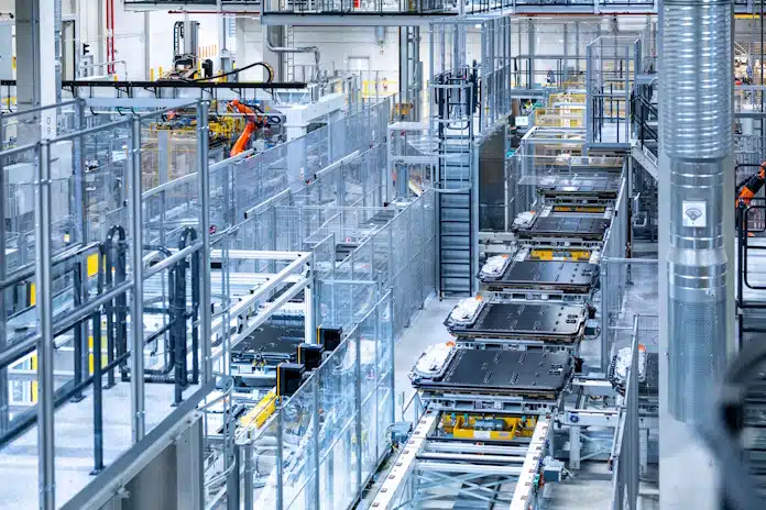 Automated conveyor belts and safety fencing on a modern factory production line.
